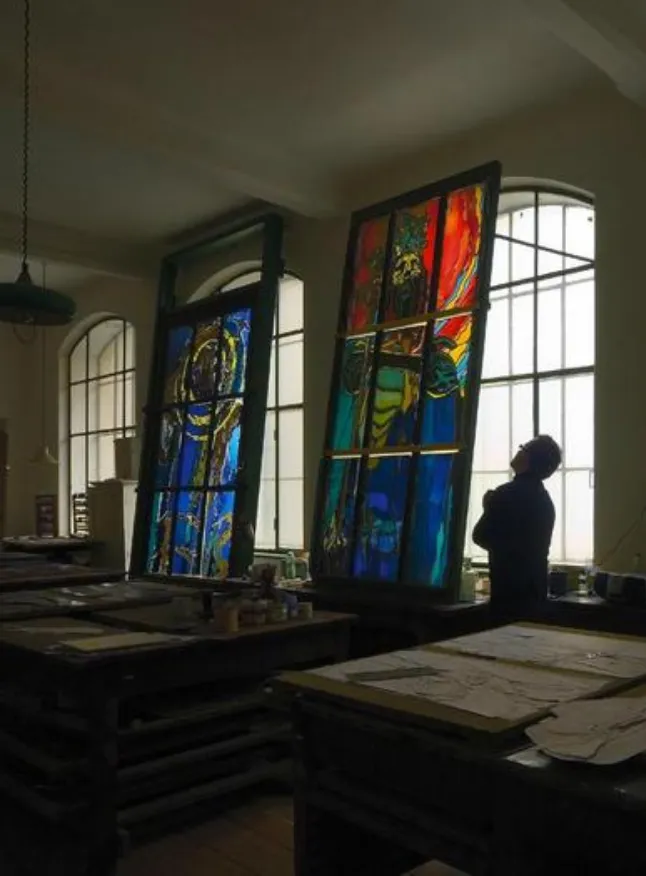 Inspecting stained glass windows in a restoration studio